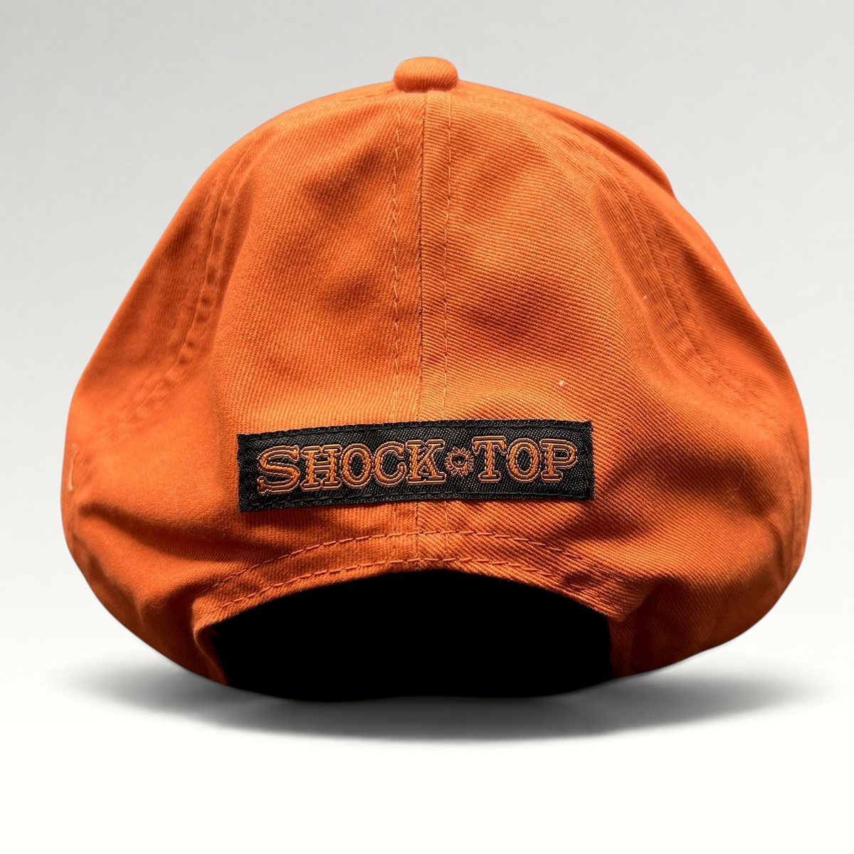 Raree Finds orange cotton strapback hat with black Shock Top logo patch on the back