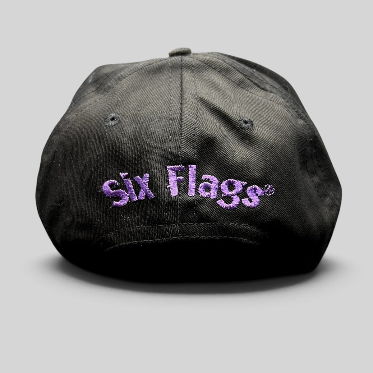 Raree Finds vintage 90s black snapback hat with purple embroidered Six Flags logo on the back