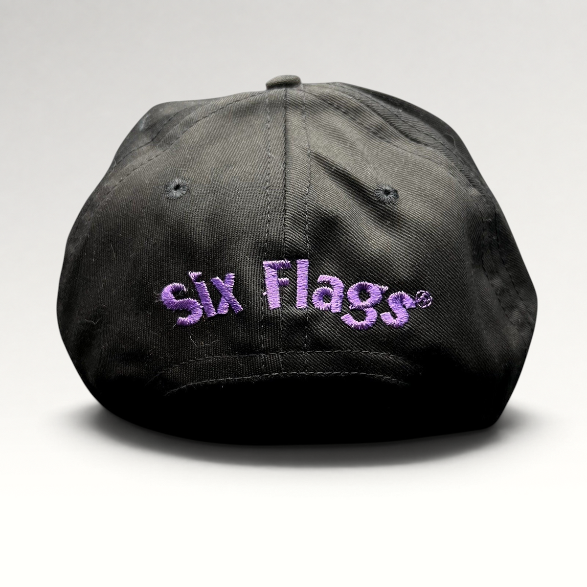 Raree Finds vintage 90s black snapback hat with purple embroidered Six Flags logo on the back