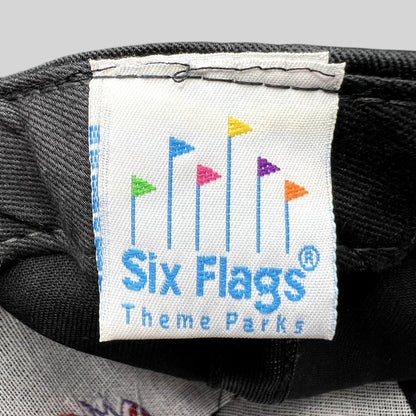 Raree Finds vintage Six Flags Theme Parks woven clothing label with colorful flag icon on black fabric