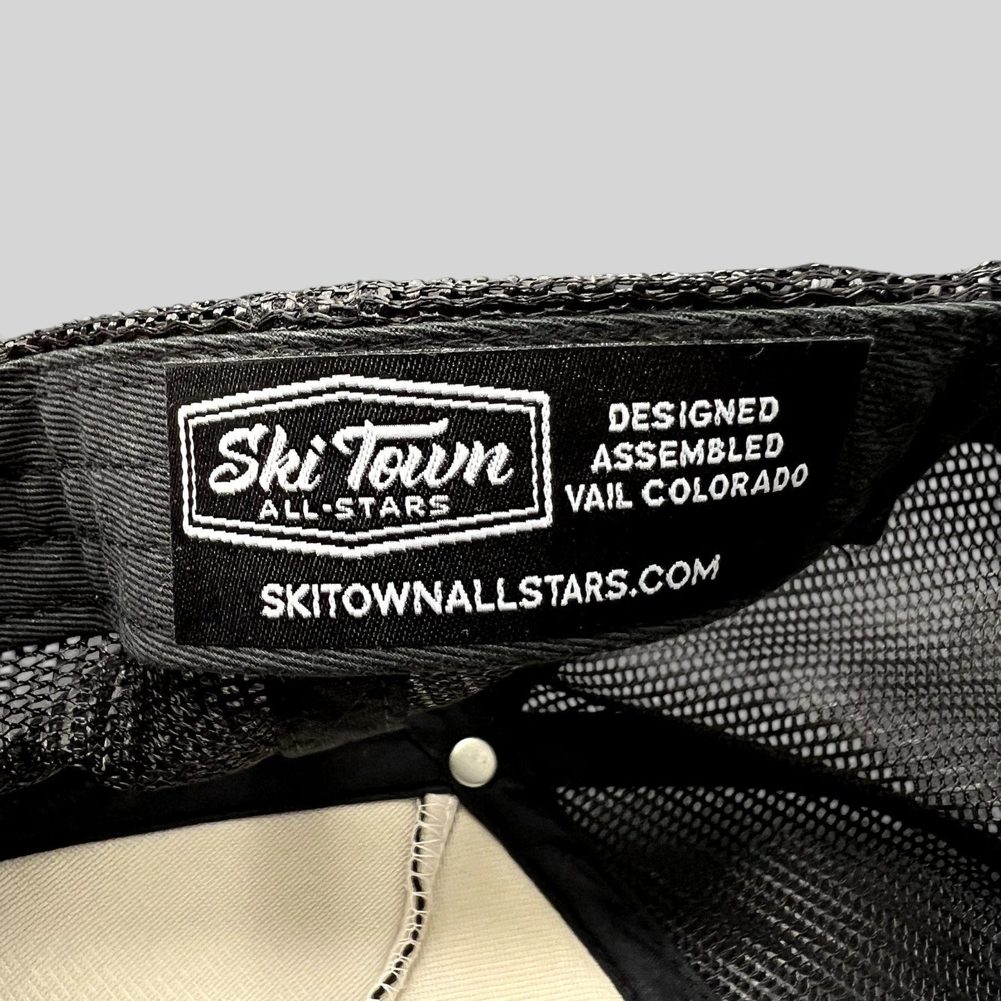 Raree Finds Ski Town All-Stars trucker hat interior label showing branding and Vail Colorado design details