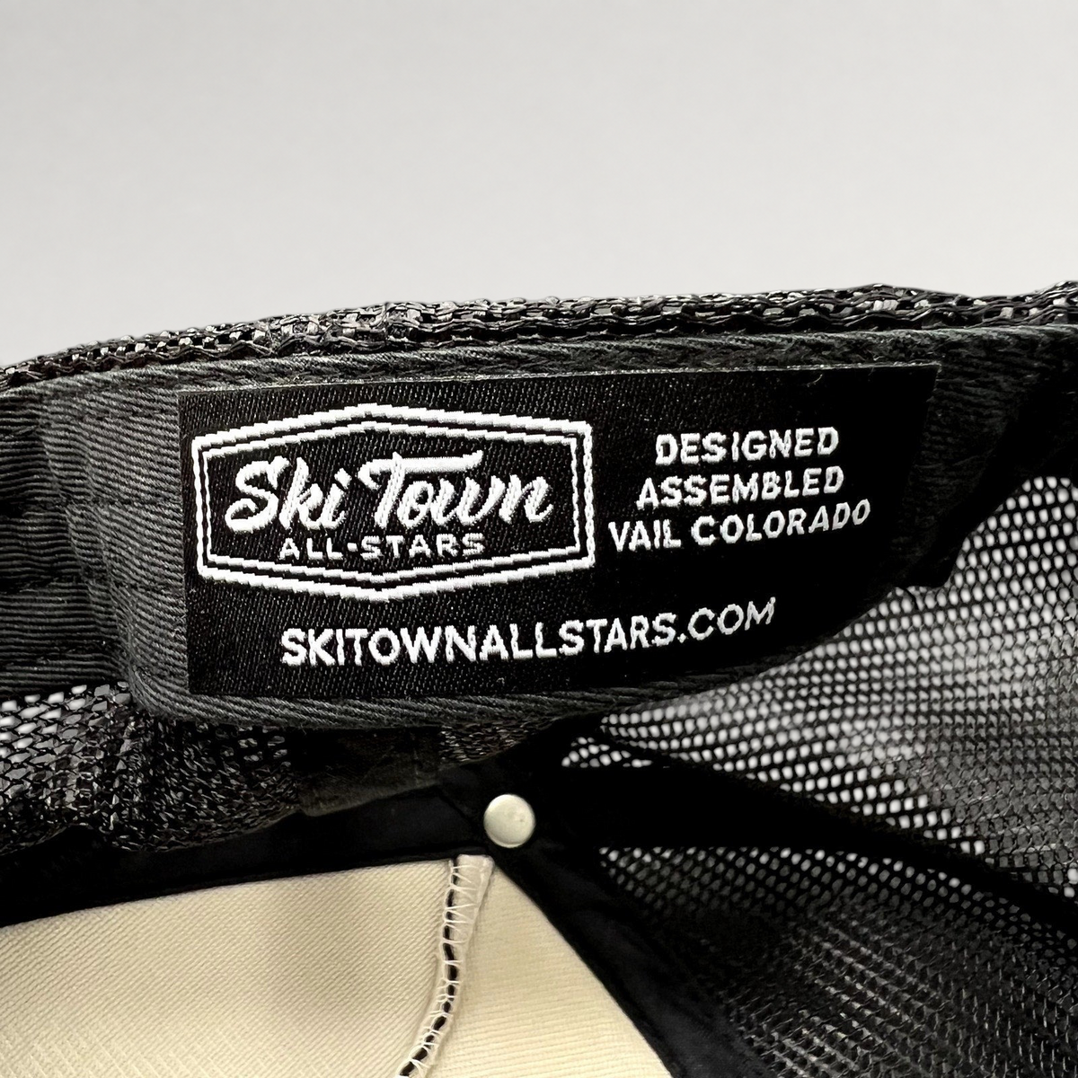 Raree Finds Ski Town All-Stars trucker hat interior label showing branding and Vail Colorado design details