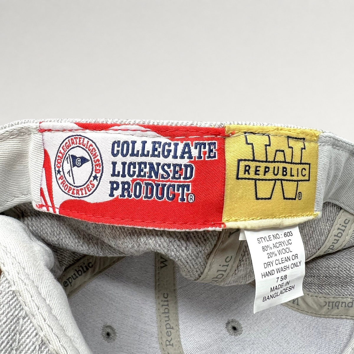 Raree Finds interior label of a W Republic SMU Mustangs hat showing collegiate licensed product and material tags.