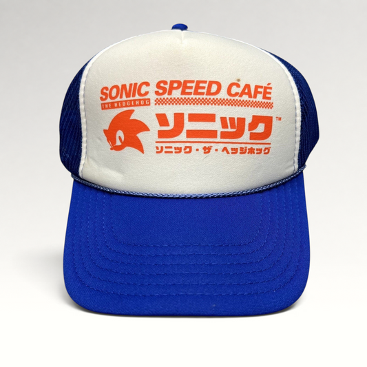 Raree Finds Sonic Speed Café trucker hat in blue and white with Japanese katakana and Sonic silhouette graphic.