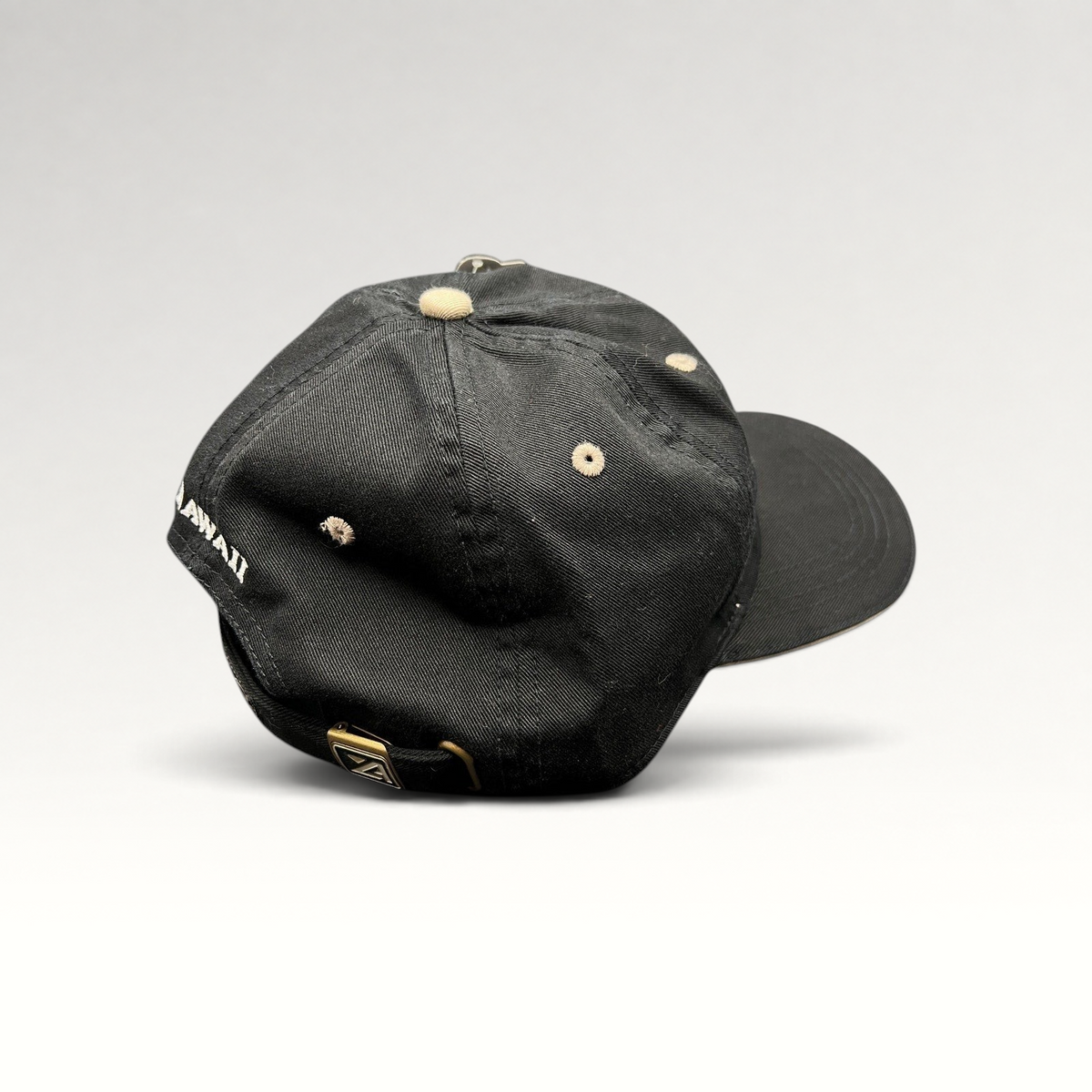 Raree Finds Sony Open Hawaii golf hat in black cotton with beige eyelets and brass buckle strapback
