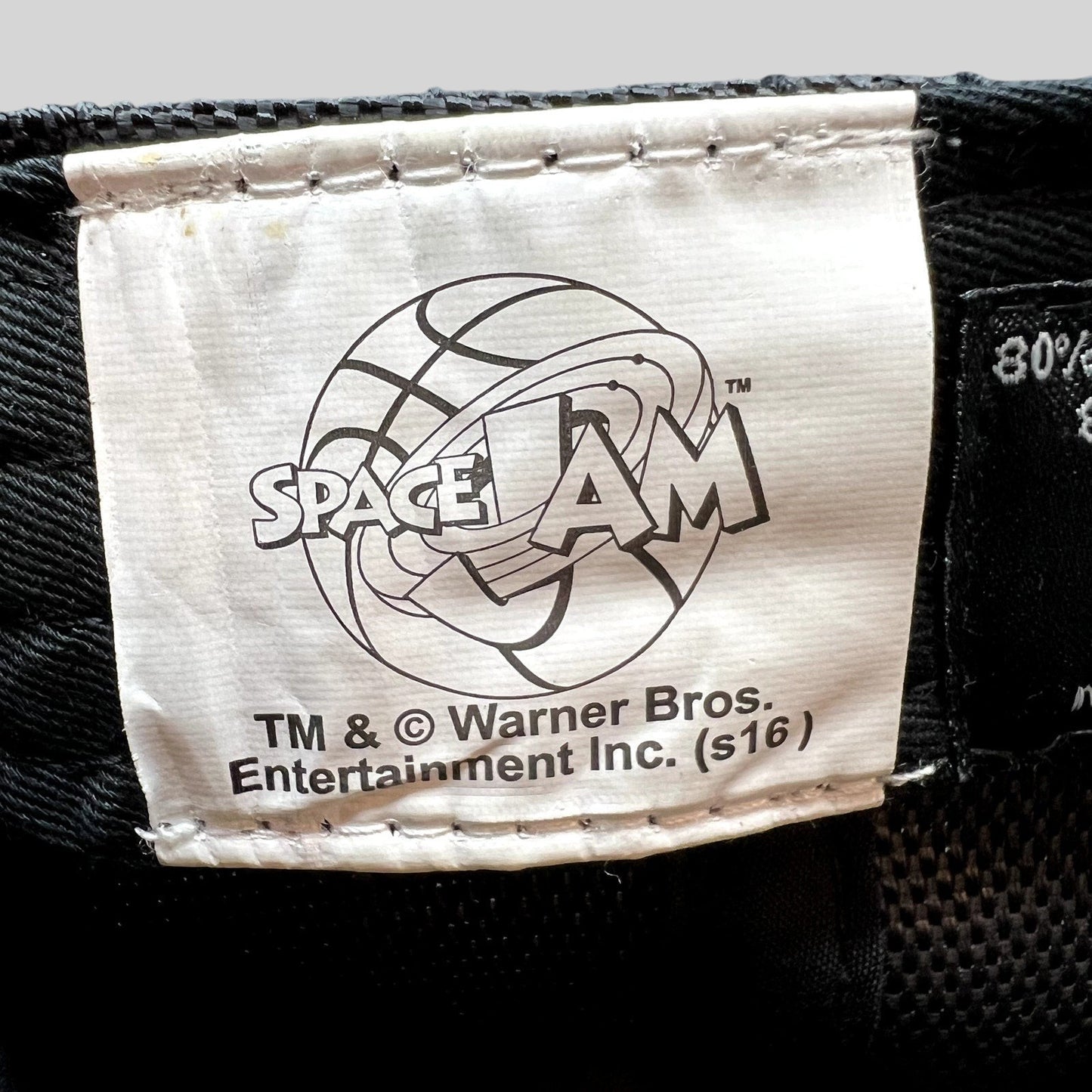 Raree Finds official 2016 Space Jam Warner Bros merchandise tag inside a black snapback hat