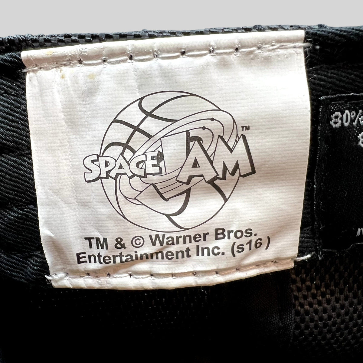 Raree Finds official 2016 Space Jam Warner Bros merchandise tag inside a black snapback hat