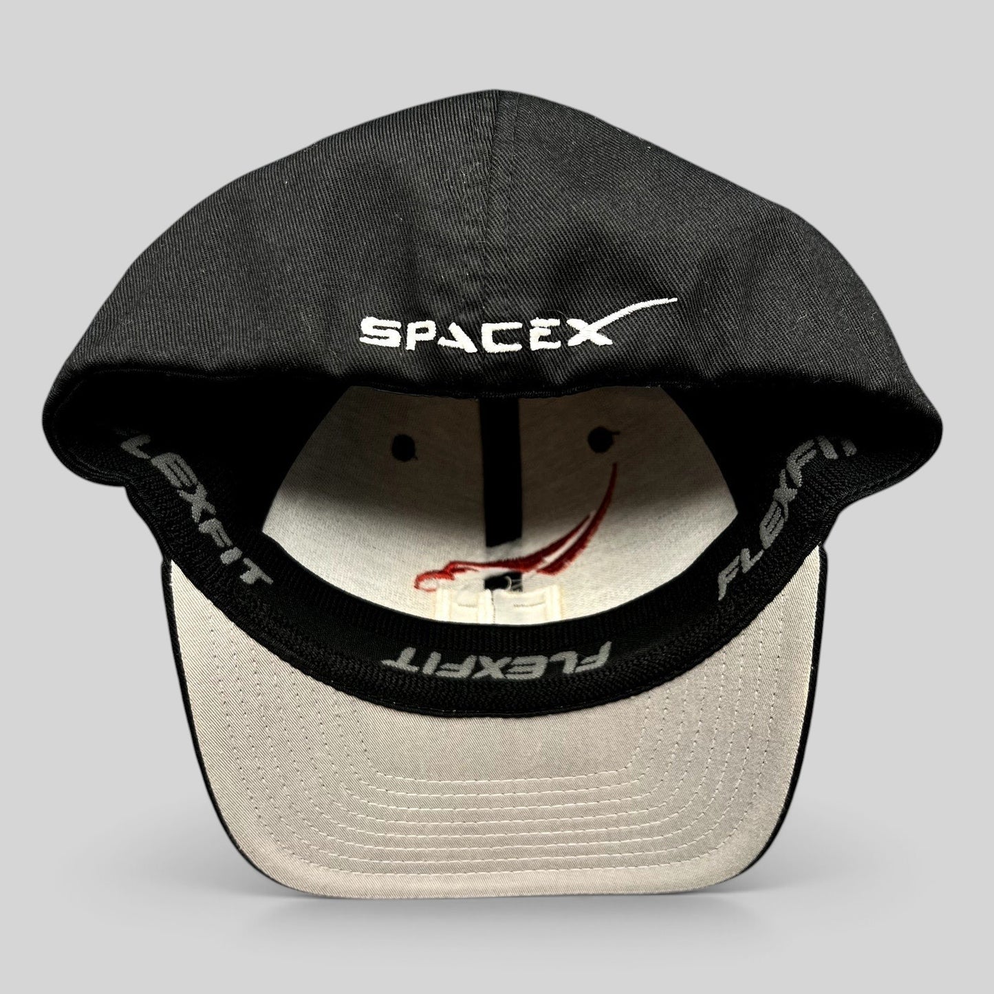 Raree Finds SpaceX Falcon Heavy Flexfit hat interior showing branded sweatband and embroidered logo on black crown