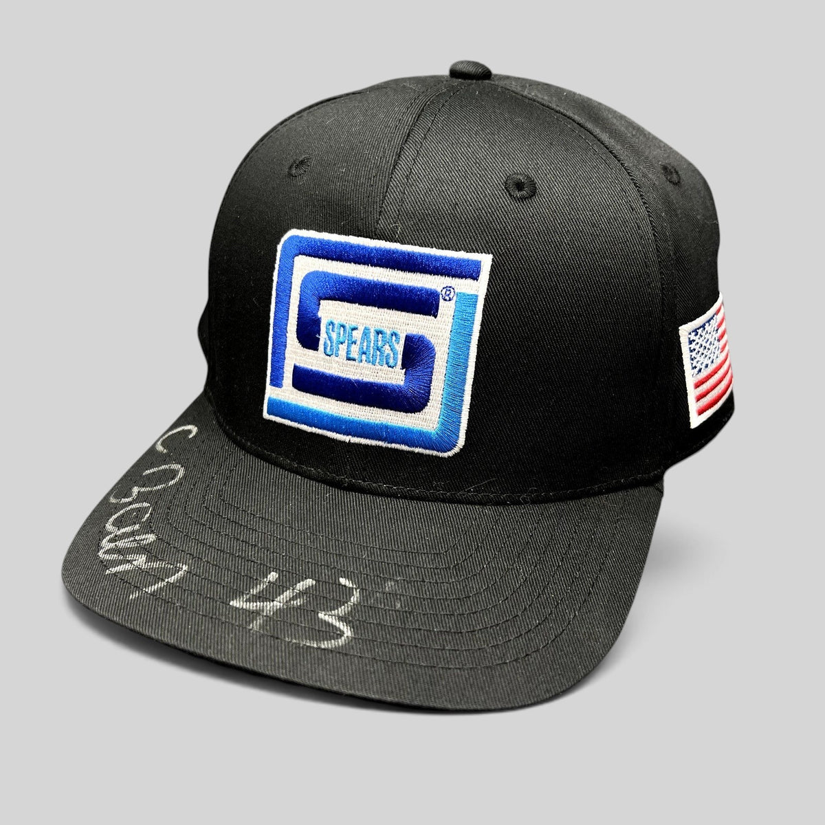 Raree Finds black snapback hat with blue Spears logo, American flag patch, and silver autograph on the brim.