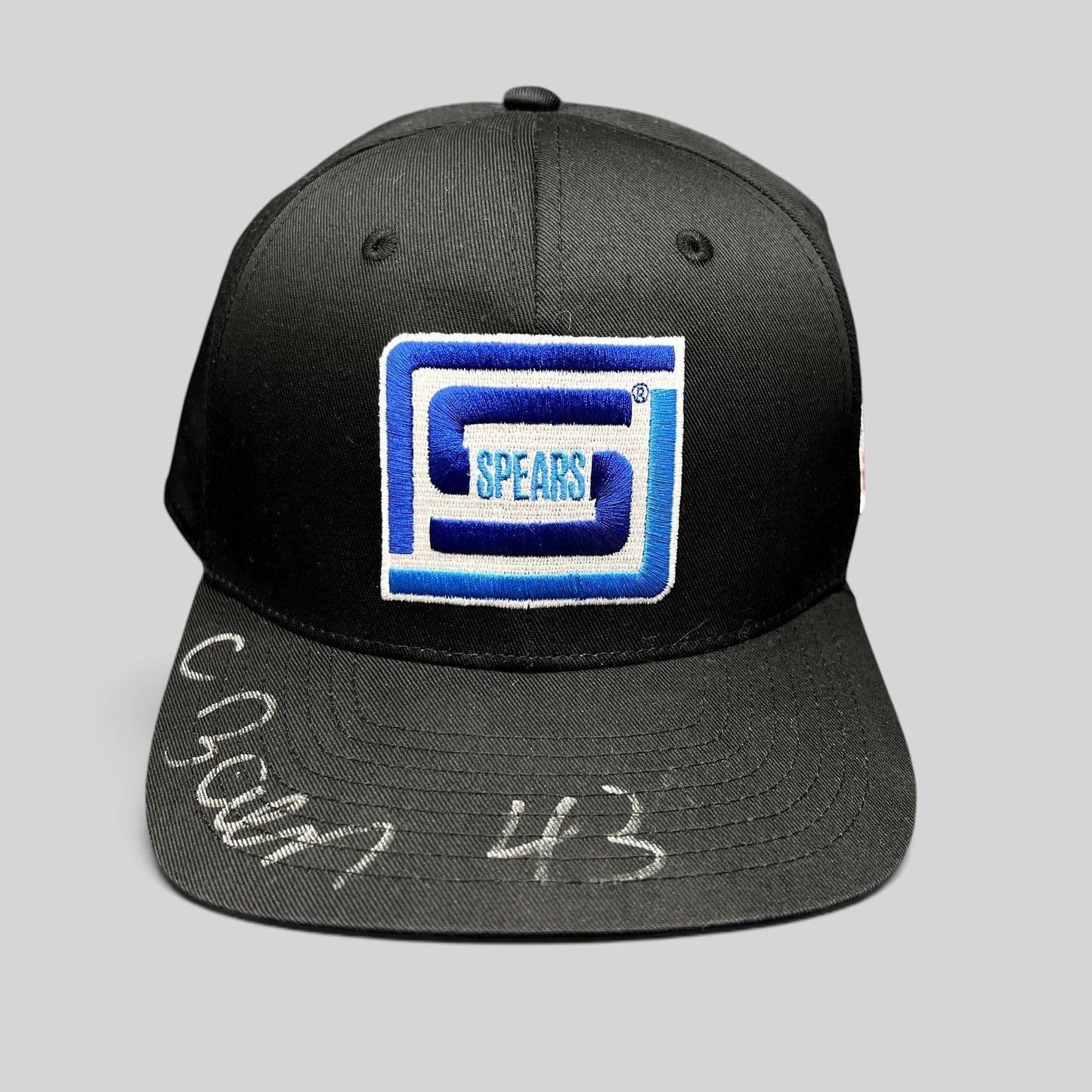 Raree Finds vintage black snapback hat with blue and white embroidered Spears logo and silver autograph on the brim.