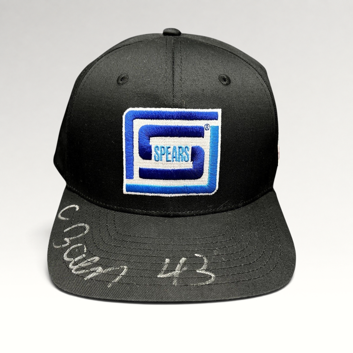 Raree Finds vintage black snapback hat with blue and white embroidered Spears logo and silver autograph on the brim.