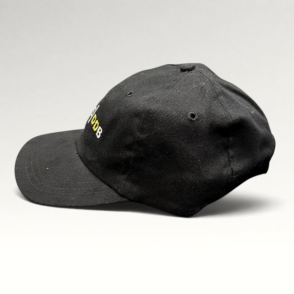 Raree Finds vintage black brushed cotton strapback hat with white and gold embroidered Spike DDB creative agency logo.