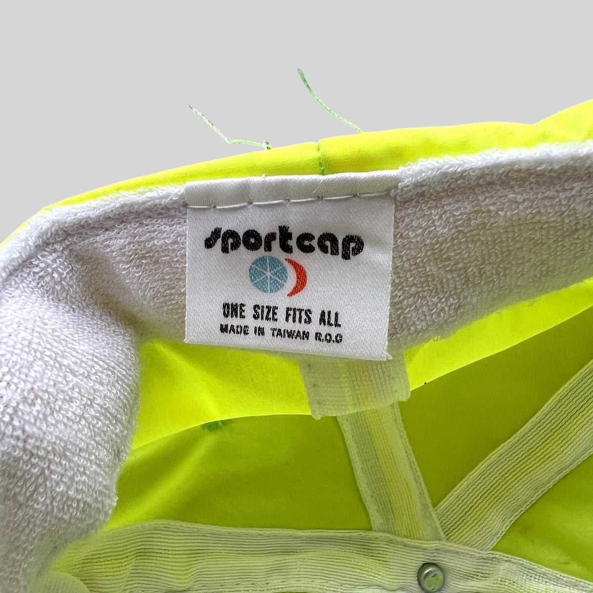 Raree Finds vintage Sportcap neon yellow nylon hat interior label showing manufacturing details and origin