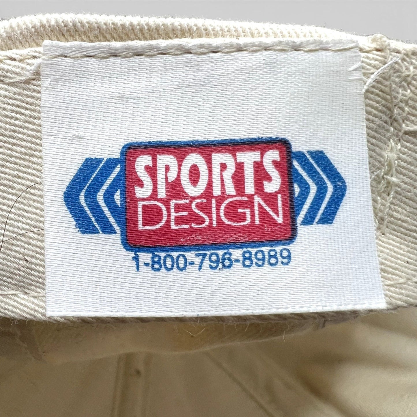 Raree Finds vintage Sports Design label inside a NASCAR snapback hat with blue and red logo text