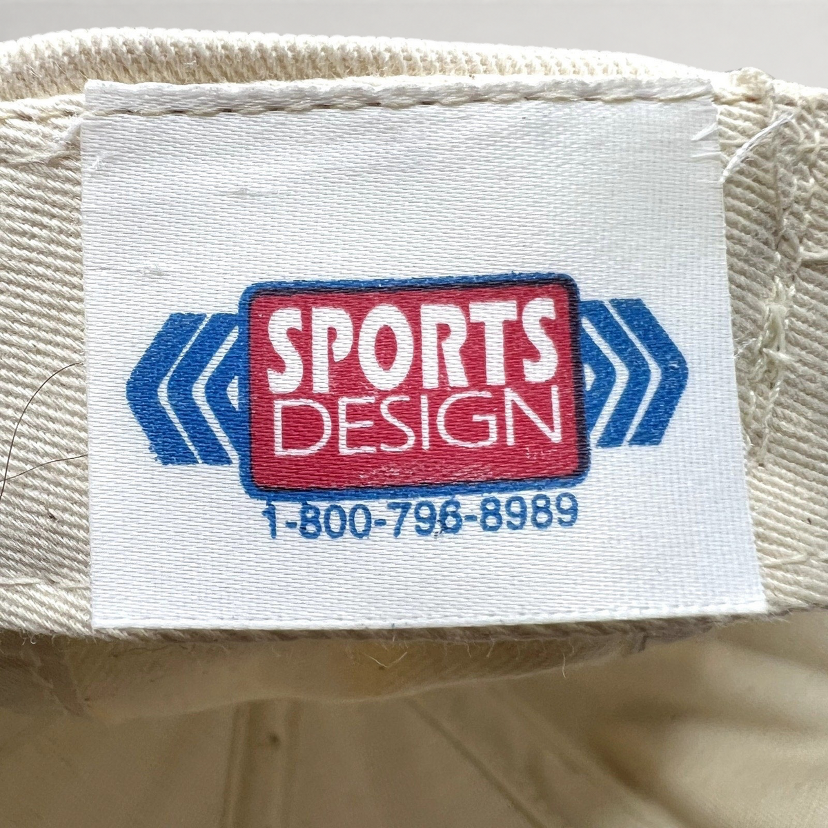 Raree Finds vintage Sports Design label inside a NASCAR snapback hat with blue and red logo text