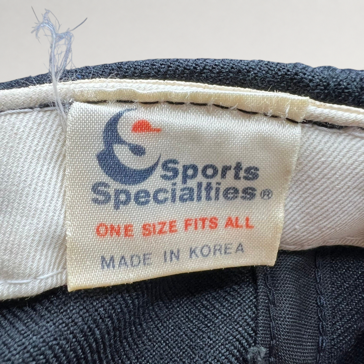 Raree Finds vintage Sports Specialties cap interior label showing brand logo, one size fits all, and made in Korea