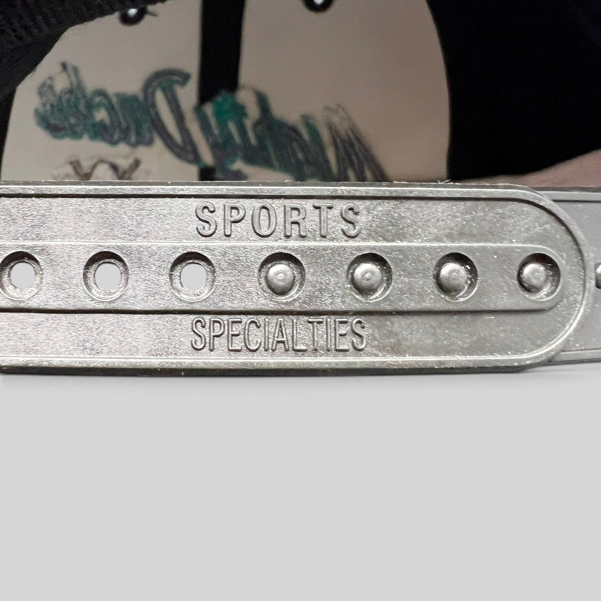 Raree Finds vintage Sports Specialties snapback hat showing the embossed plastic closure detail