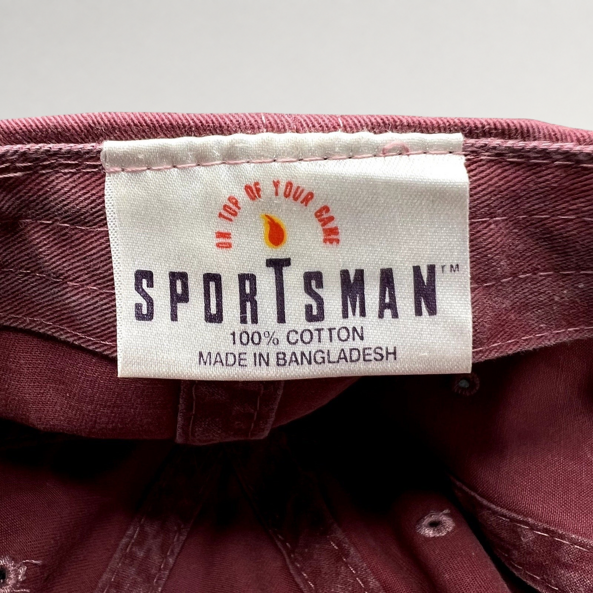 Raree Finds vintage Sportsman maroon cotton dad cap interior label showing 100% cotton and brand logo