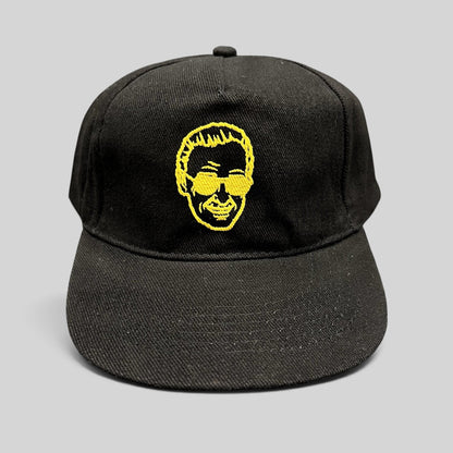 Raree Finds black strapback hat featuring gold embroidered Stan Lee portrait from 2019 Riyadh SuperCon event.