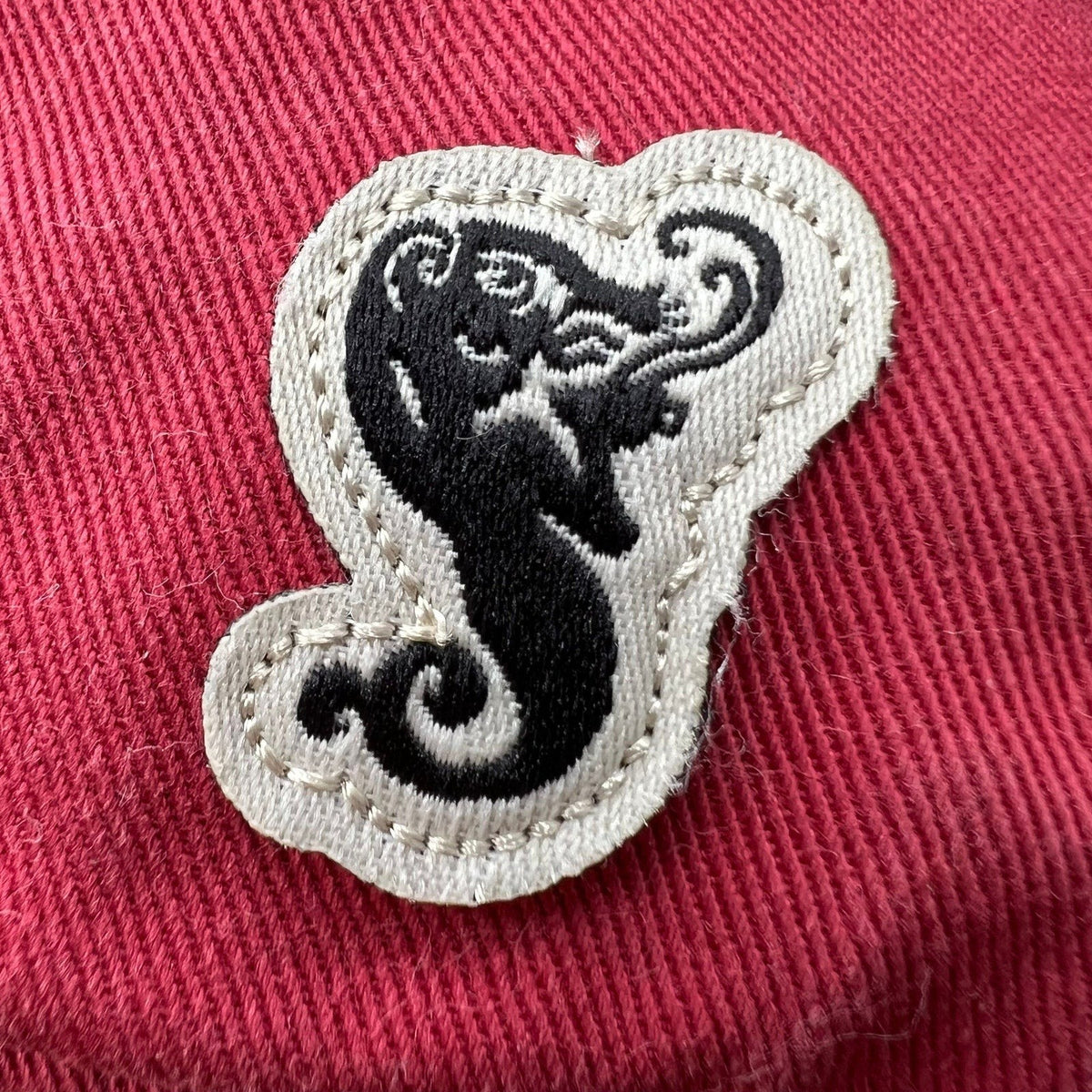 Raree Finds Starbucks siren mermaid patch detail on a red cotton strapback hat