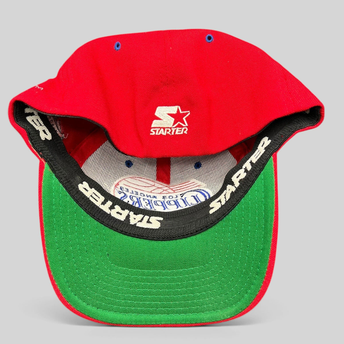 Raree Finds vintage Starter LA Clippers red cap with green underbrim and interior branded sweatband