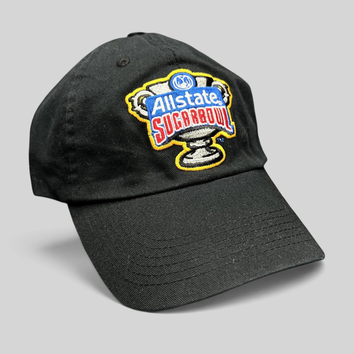Raree Finds black Bayou Apparel strapback hat featuring an embroidered Allstate Sugar Bowl trophy logo on the front.