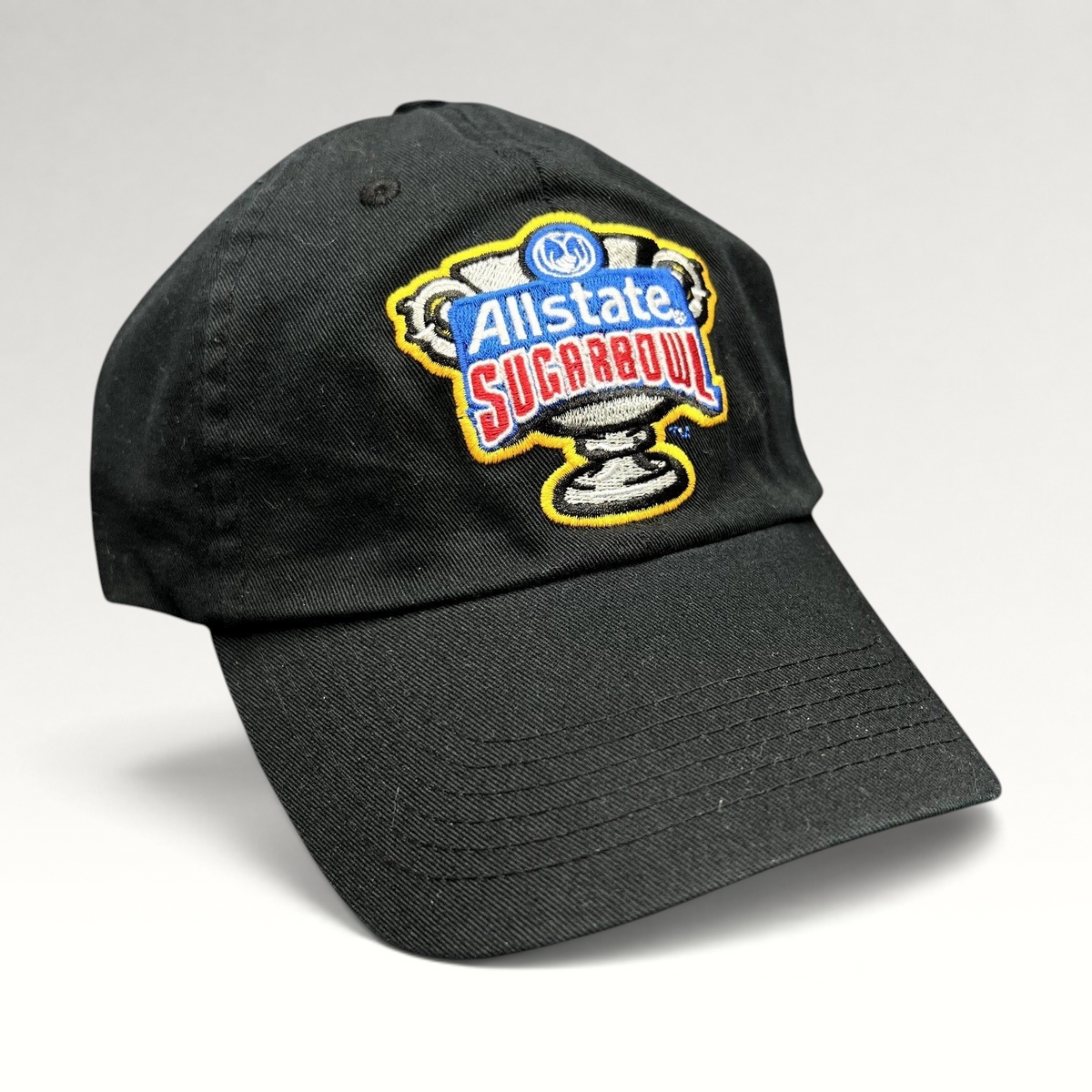 Raree Finds black Bayou Apparel strapback hat featuring an embroidered Allstate Sugar Bowl trophy logo on the front.