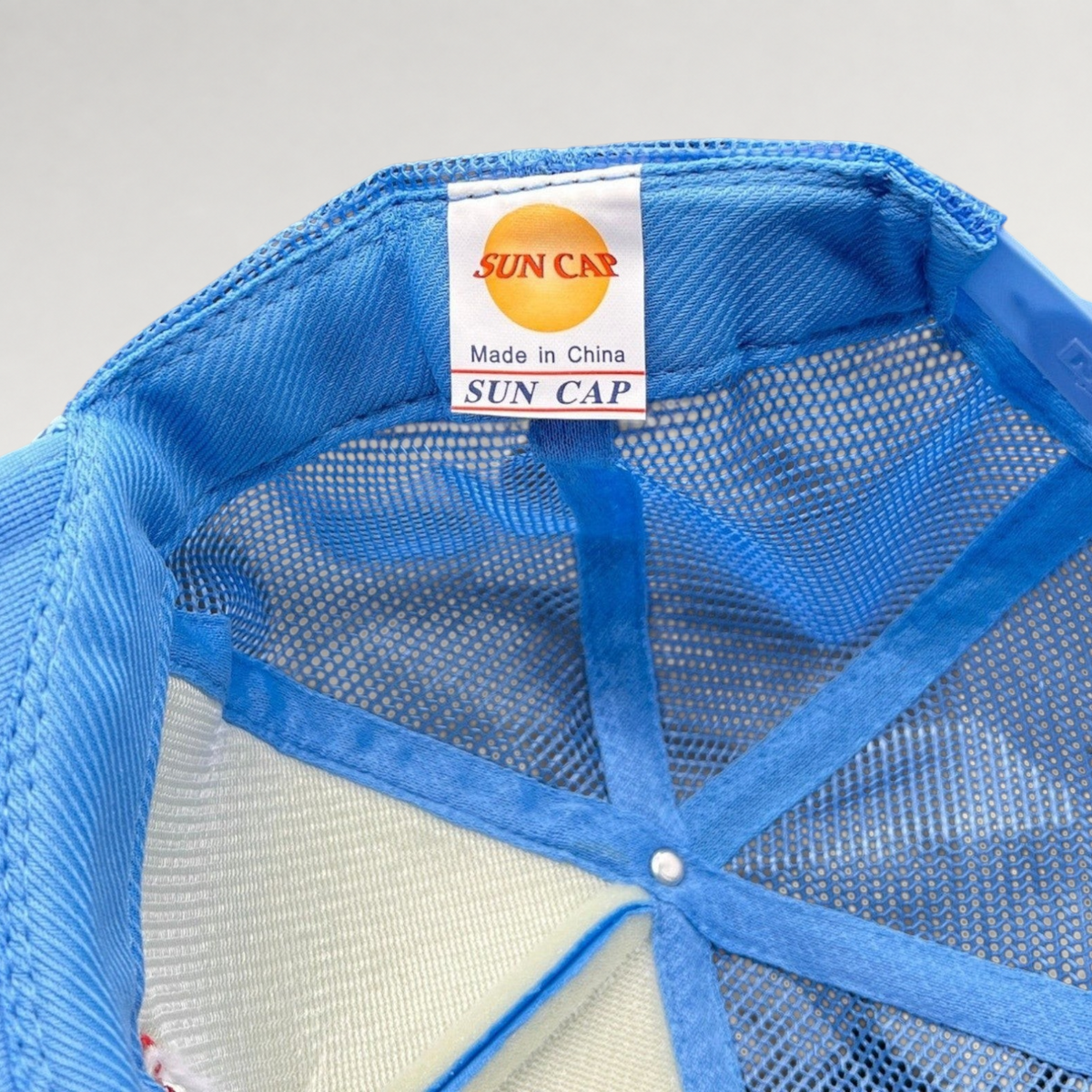 Raree Finds light-blue Sun Cap trucker hat interior showing brand label and mesh construction