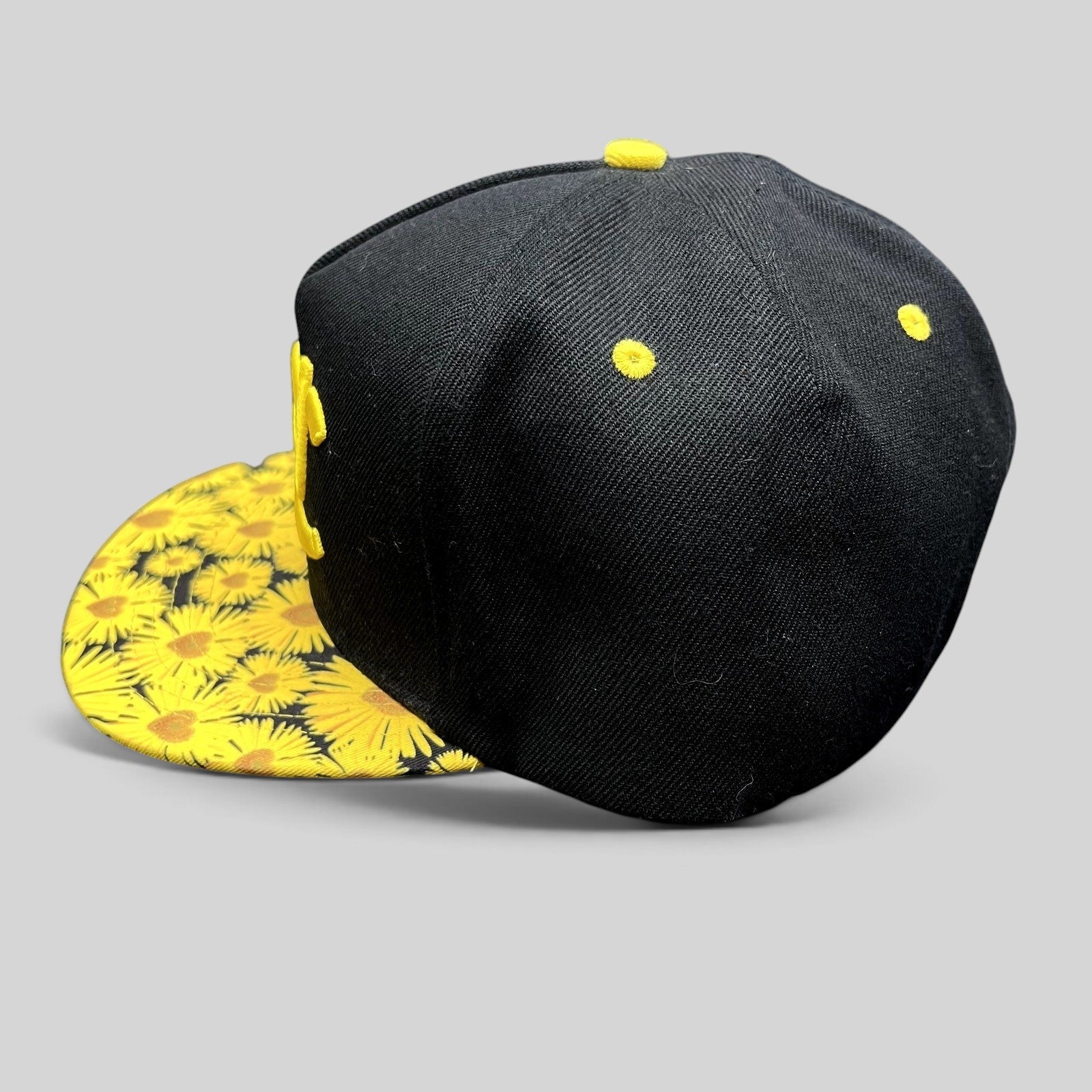 Raree Finds black snapback hat with a yellow sunflower print flat brim and yellow embroidered EDC logo