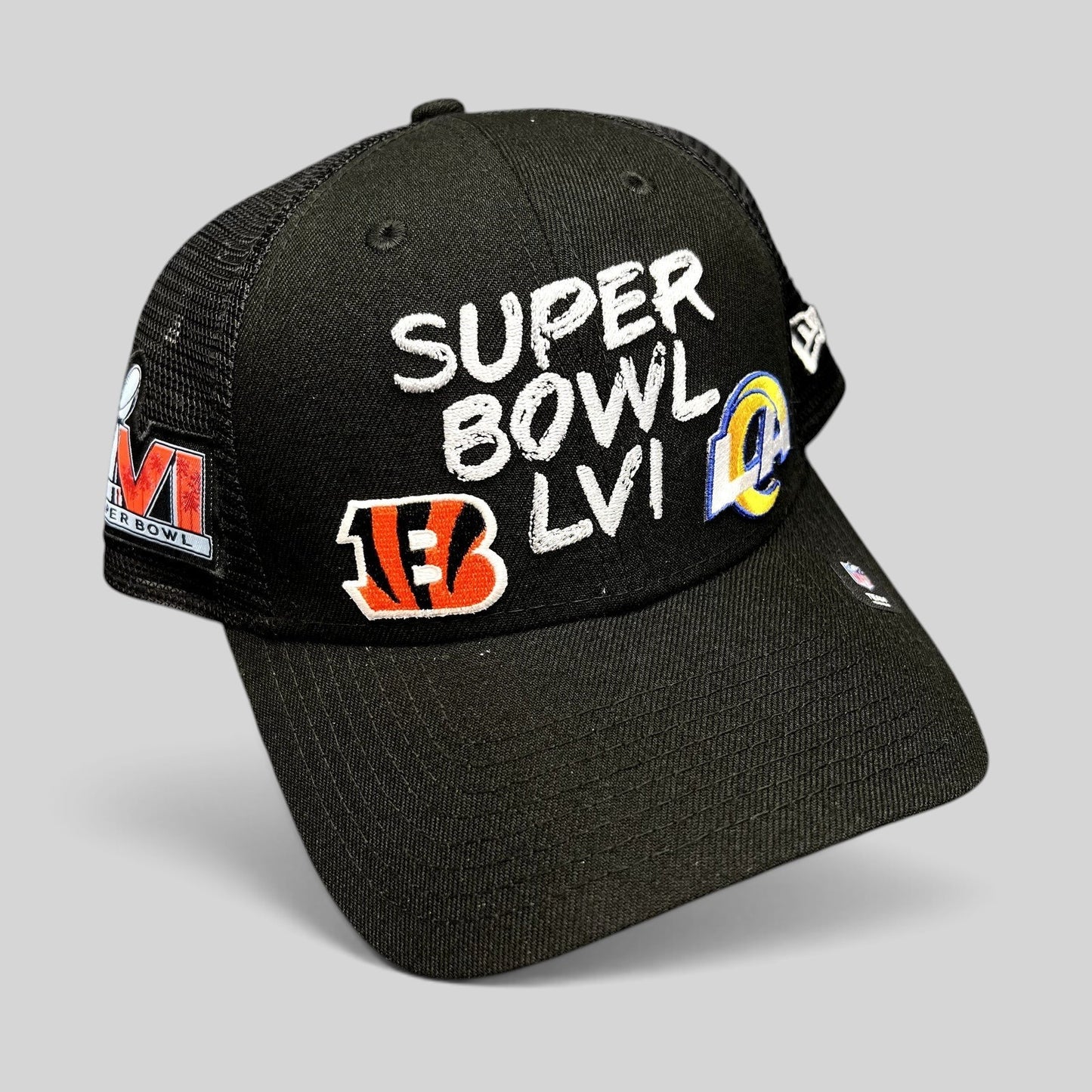 Raree Finds black New Era Super Bowl LVI trucker snapback hat with Bengals and Rams team logos and mesh back panels.
