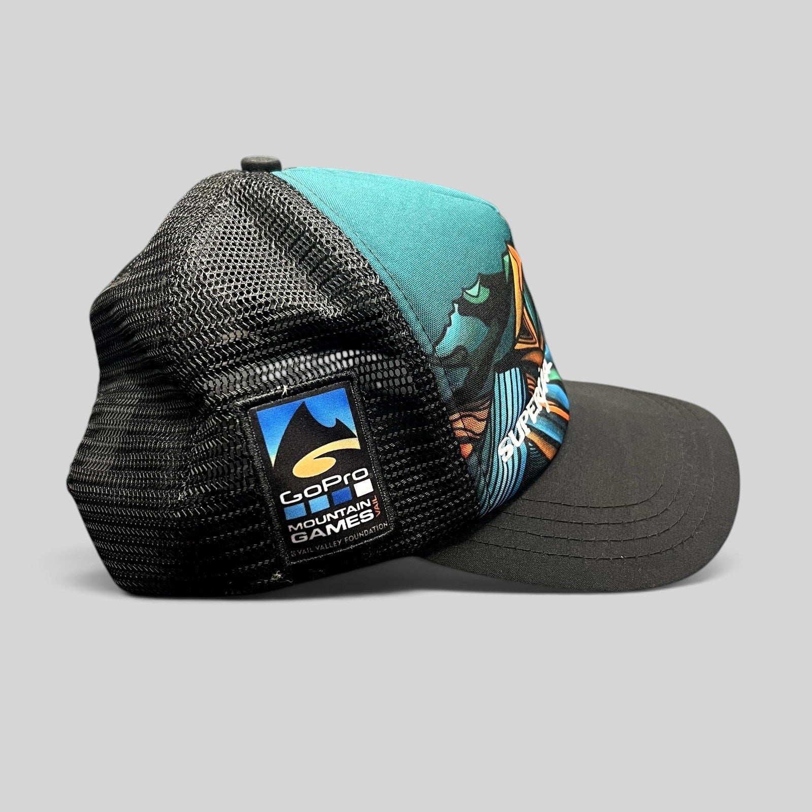 Raree Finds Superfeet GoPro Mountain Games trucker hat with black mesh back and colorful mountain graphic front panel