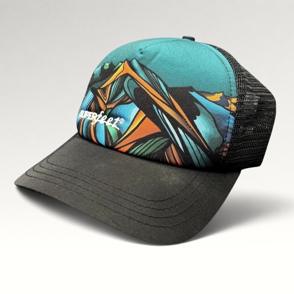 Raree Finds Superfeet GoPro Mountain Games trucker hat with colorful abstract mountain graphic and black mesh back.