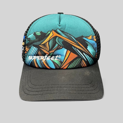 Raree Finds Superfeet GoPro Mountain Games trucker hat with abstract mountain graphic, black mesh, and snapback closure.