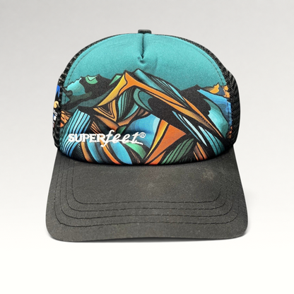 Raree Finds Superfeet GoPro Mountain Games trucker hat with abstract mountain graphic, black mesh, and snapback closure.