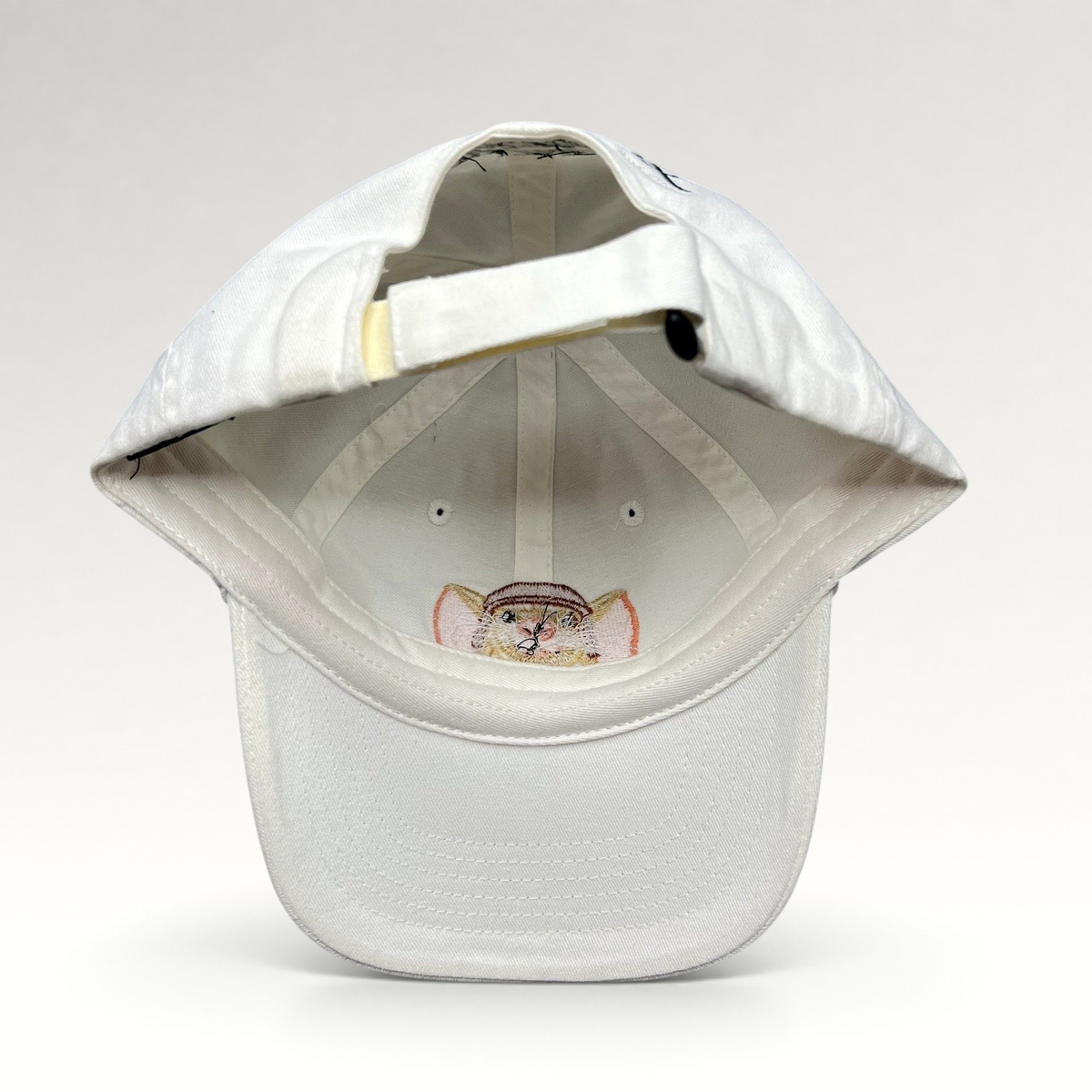 Raree Finds white cotton youth strapback hat featuring an embroidered Tale of Despereaux mouse character graphic