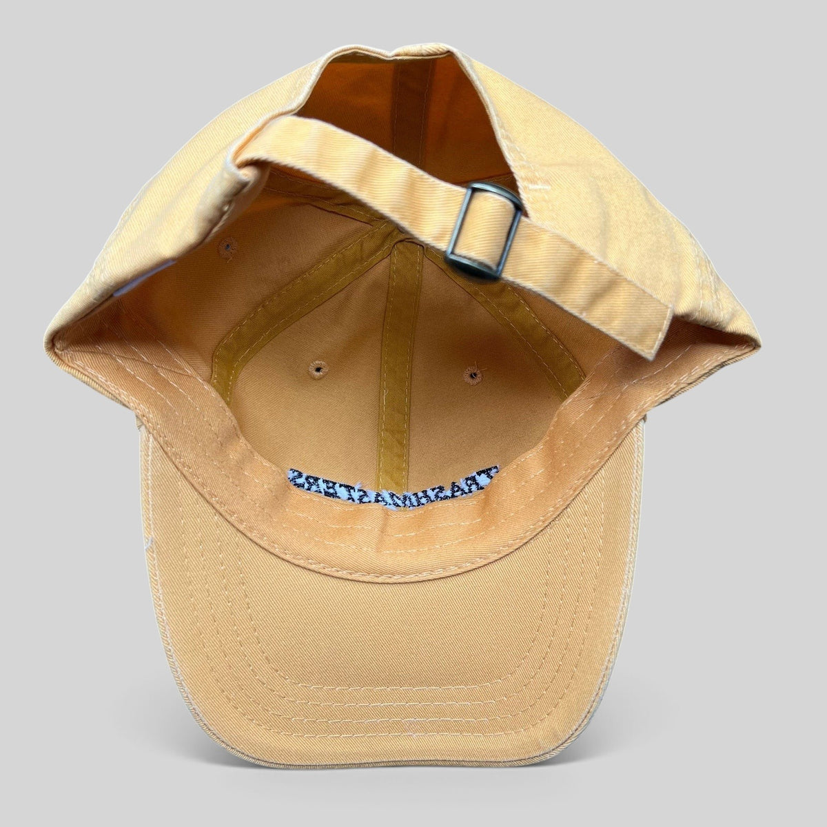 Raree Finds vintage tan cotton strapback dad cap with adjustable metal buckle and interior Trashmasters branding
