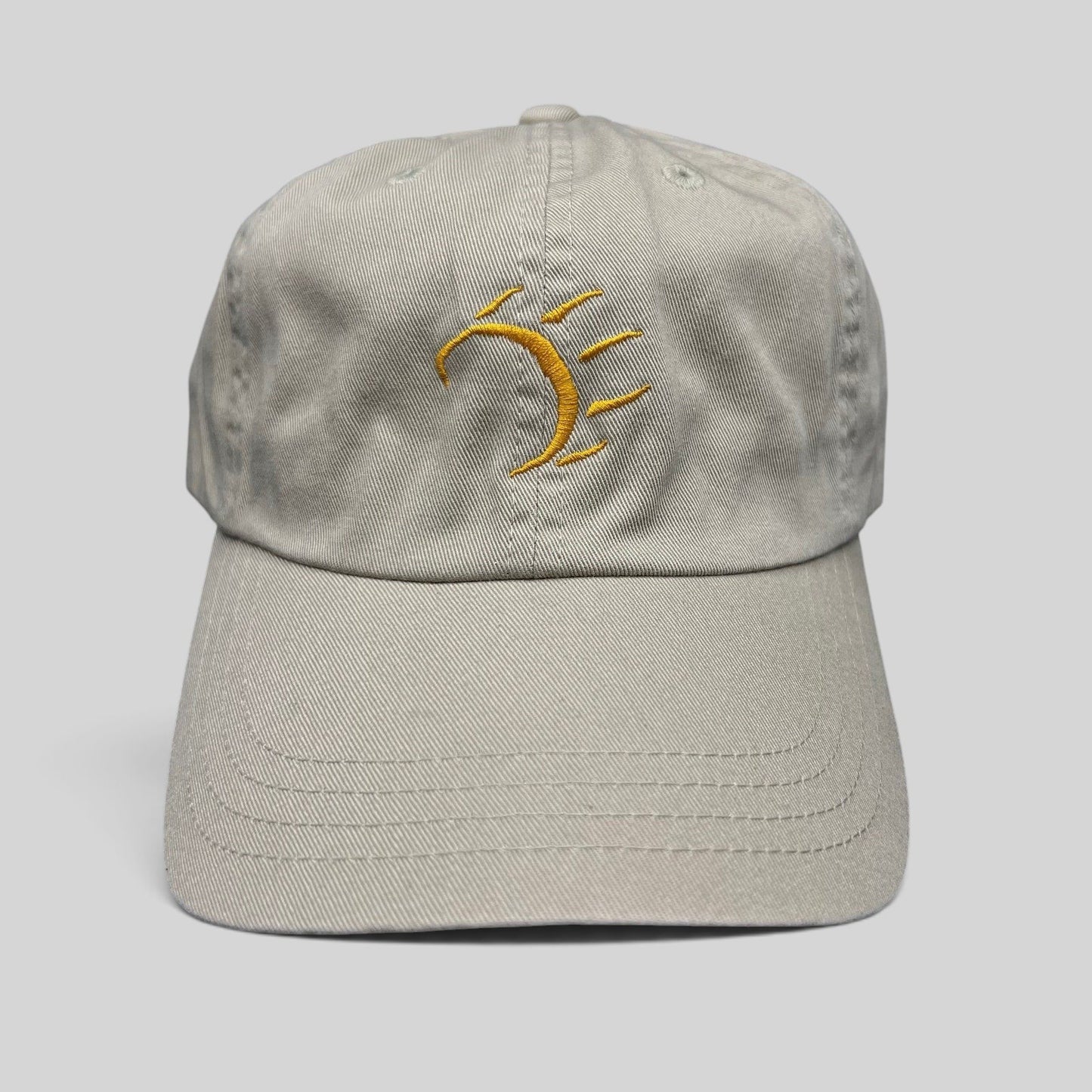 Raree Finds vintage tan cotton strapback hat with a minimalist gold embroidered dancing bear graphic on the front.