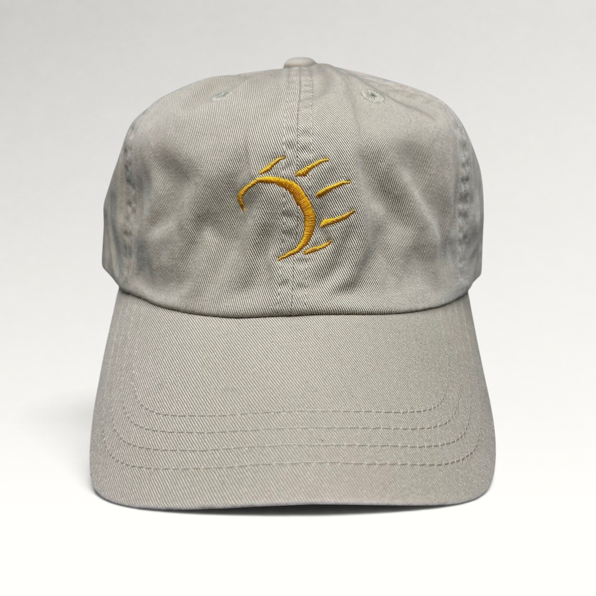 Raree Finds vintage tan cotton strapback hat with a minimalist gold embroidered dancing bear graphic on the front.