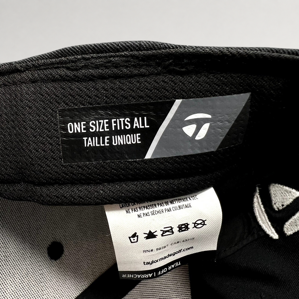 Raree Finds TaylorMade golf hat interior label showing one size fits all sizing and care instructions