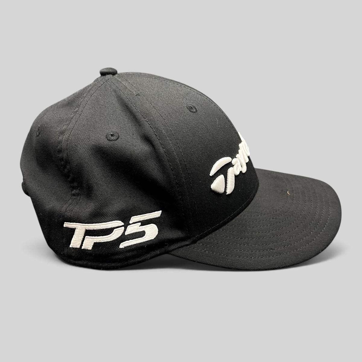 Raree Finds black TaylorMade TP5 golf snapback hat with raised white embroidery on the front and side panels.