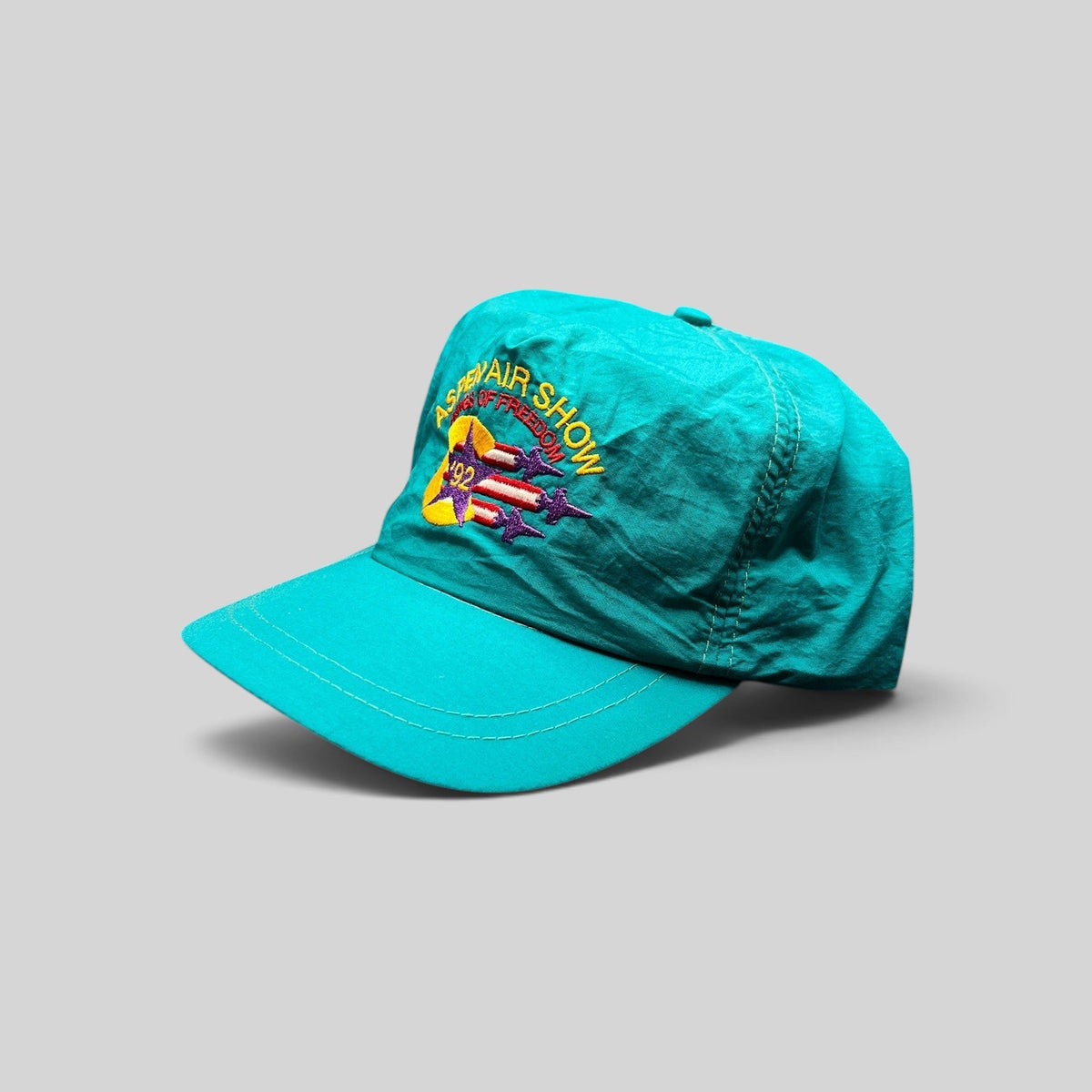 Raree Finds vintage 1992 Aspen Air Show teal nylon snapback hat with Wings of Freedom embroidered graphic