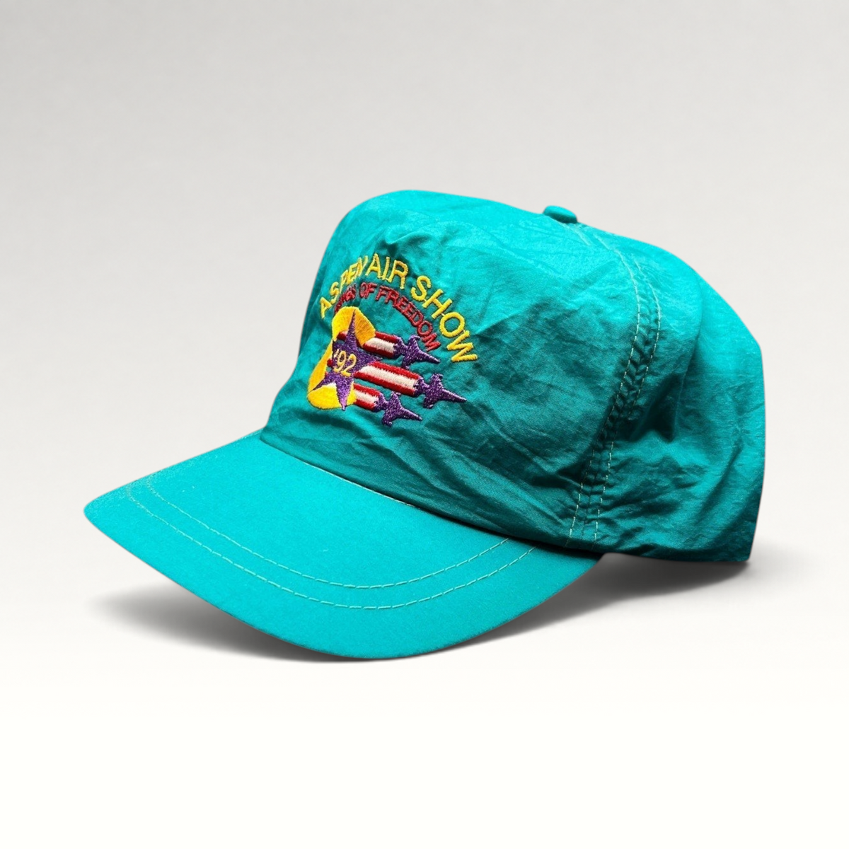 Raree Finds vintage 1992 Aspen Air Show teal nylon snapback hat with Wings of Freedom embroidered graphic