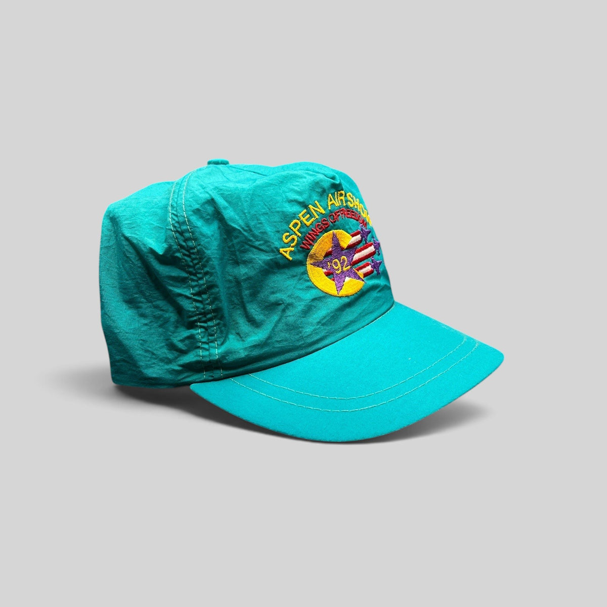 Raree Finds vintage 1992 Aspen Air Show teal nylon snapback hat with Wings of Freedom embroidered graphic