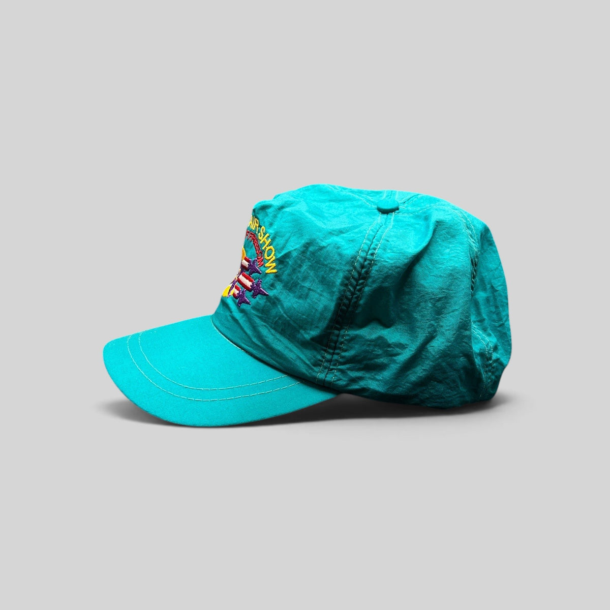 Raree Finds vintage 1992 Aspen Air Show teal nylon snapback hat with multicolor Wings of Freedom embroidery