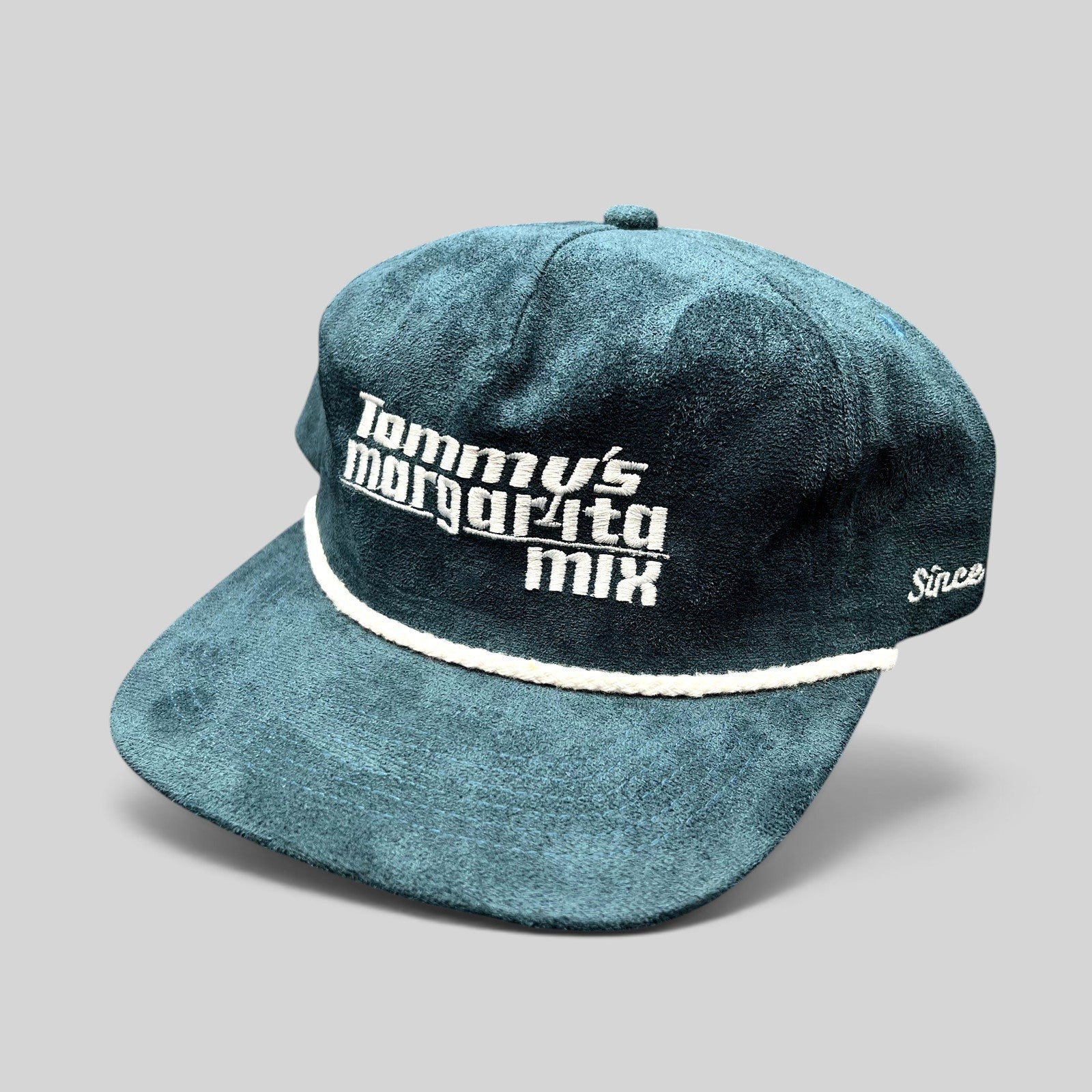 Raree Finds Calidum Aires teal suede snapback hat with white Tommy’s Margarita Mix embroidery and braided rope detail.