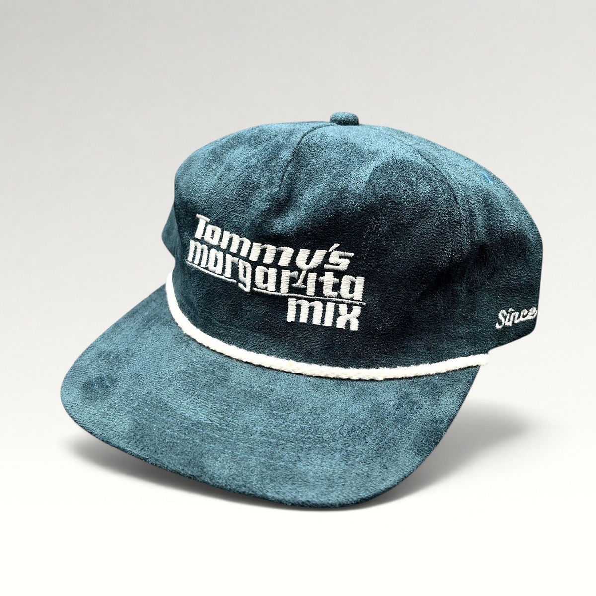 Raree Finds Calidum Aires teal suede snapback hat with white Tommy’s Margarita Mix embroidery and braided rope detail.