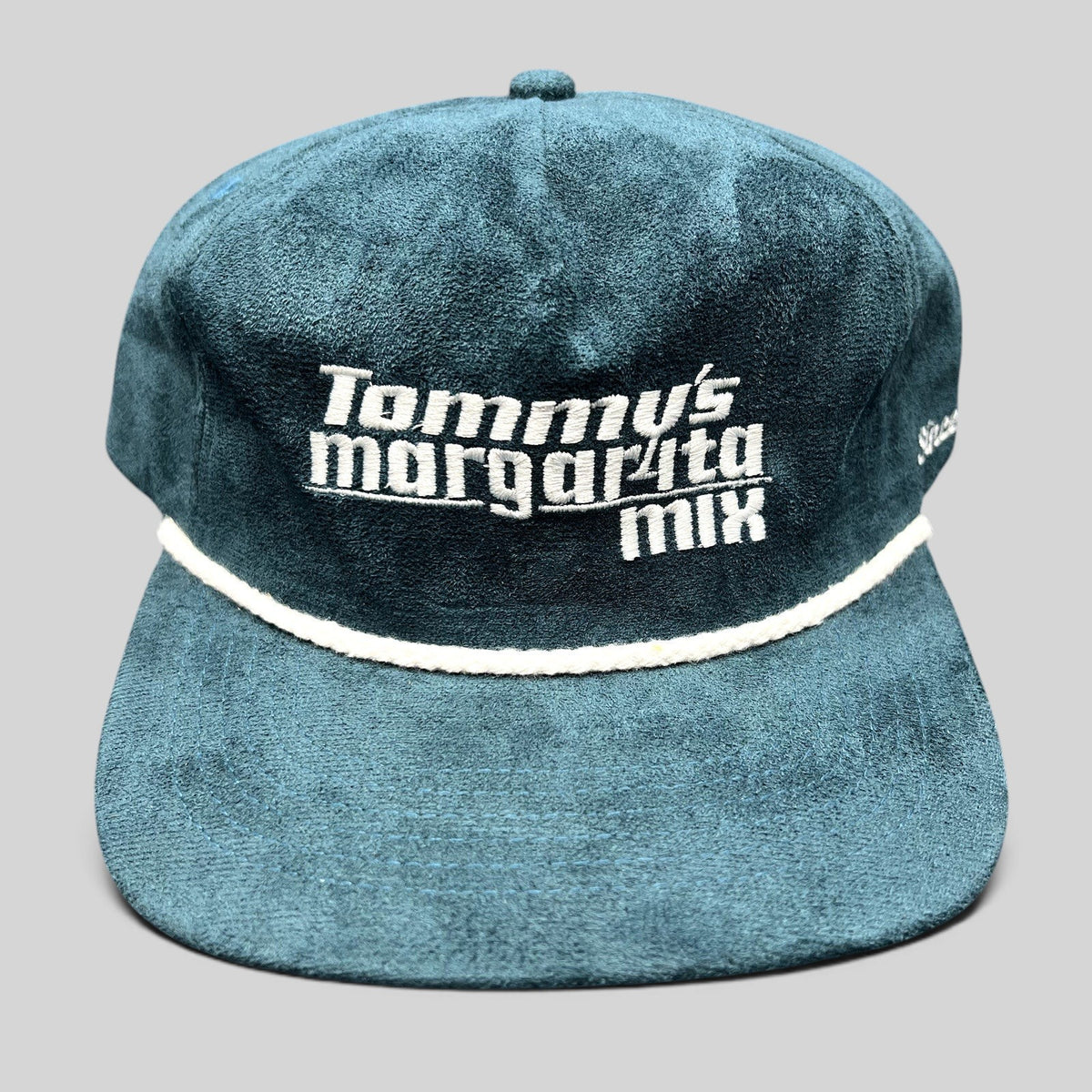 Raree Finds Calidum Aires teal suede snapback hat with white Tommy’s Margarita Mix embroidery and braided rope detail.