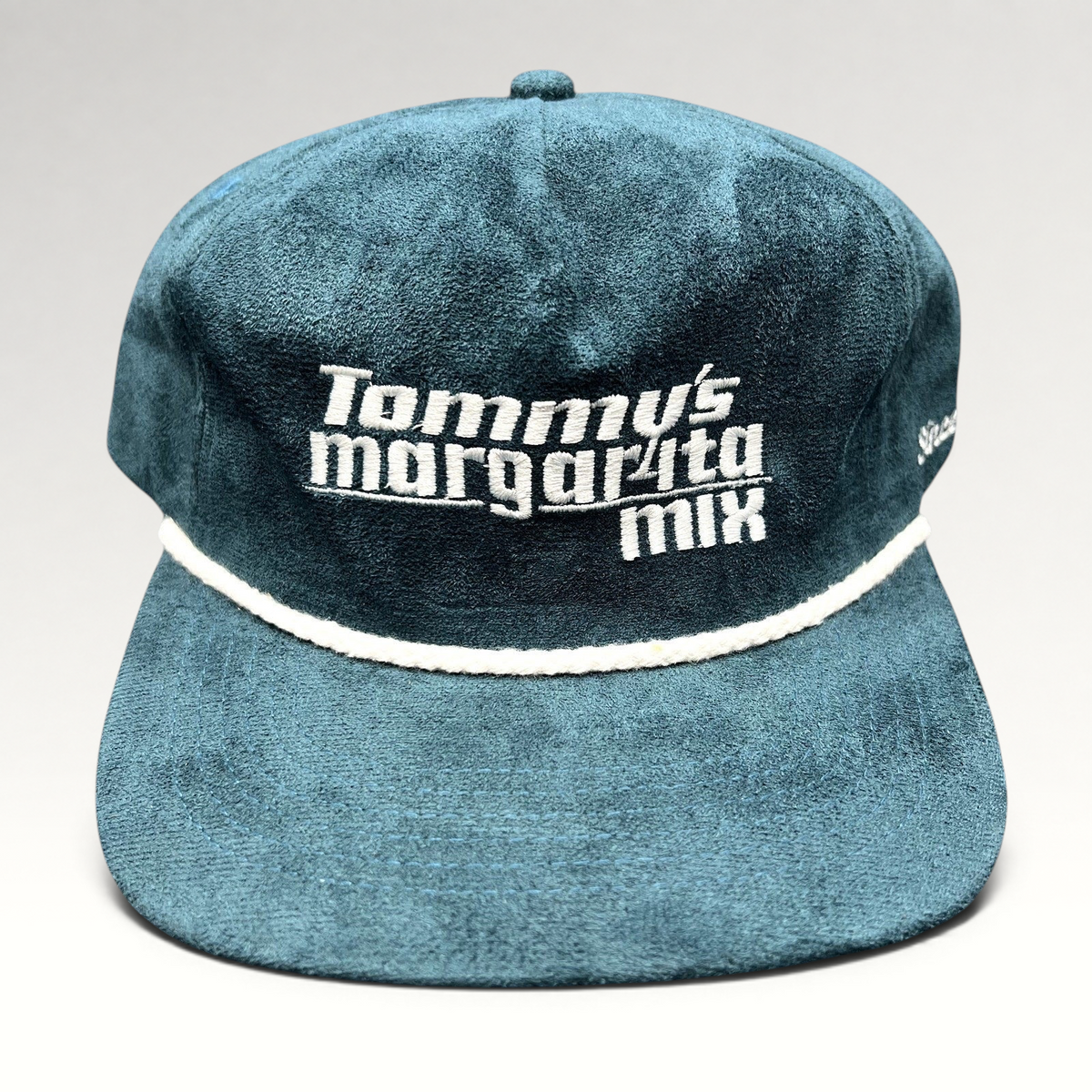 Raree Finds Calidum Aires teal suede snapback hat with white Tommy’s Margarita Mix embroidery and braided rope detail.