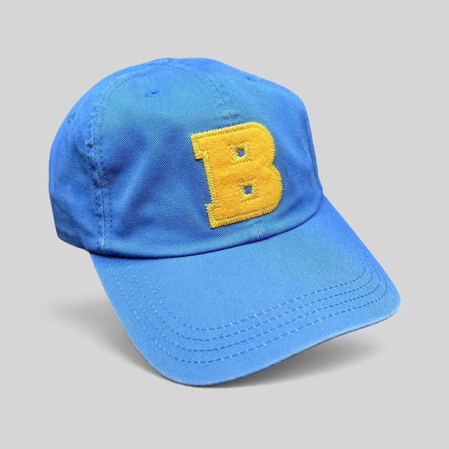 Raree Finds Ted Baker royal blue cotton dad cap with a large yellow chenille B appliqué on the front