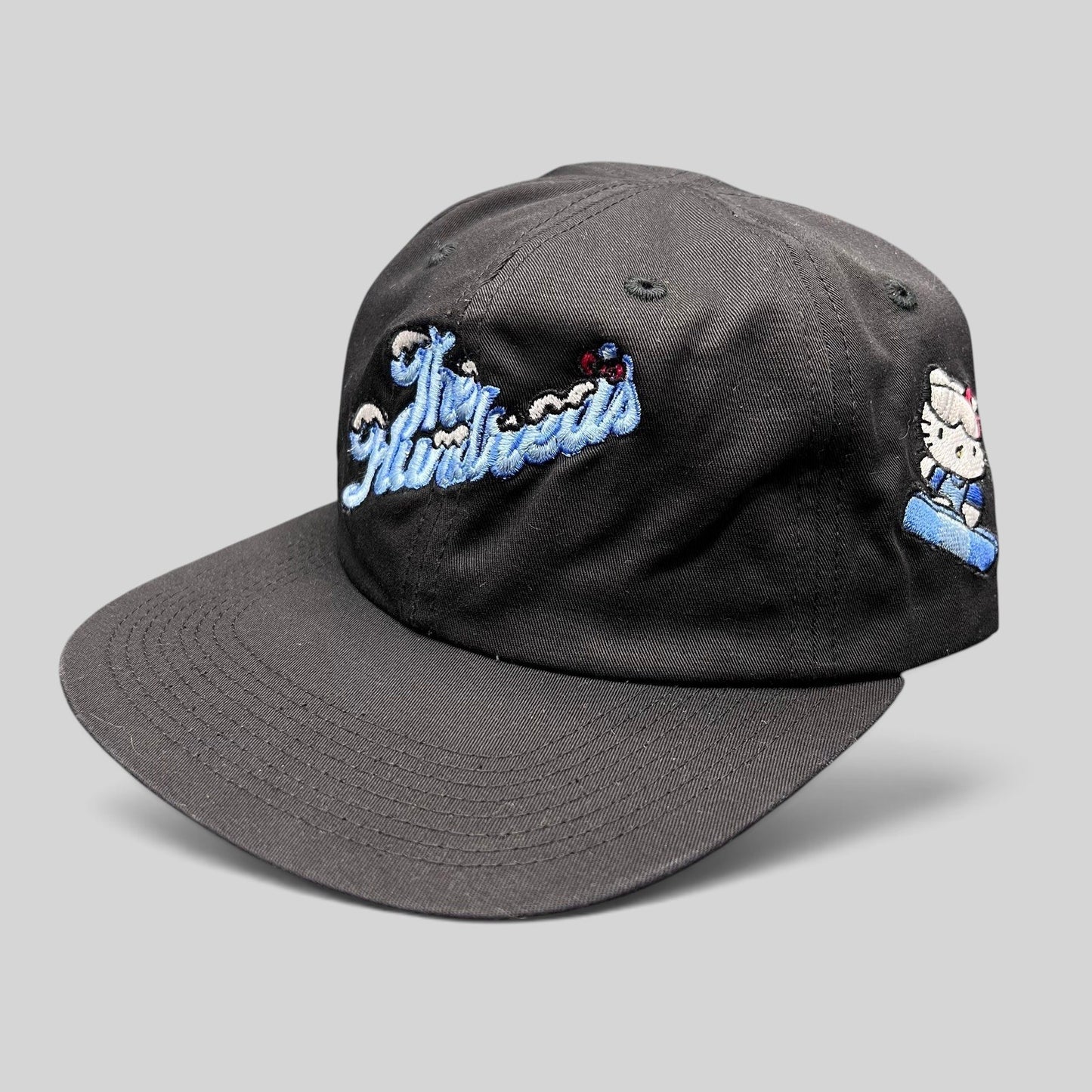 Raree Finds The Hundreds x Hello Kitty black cotton snapback hat with blue embroidered script and side character patch